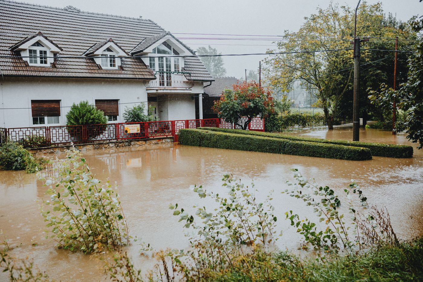 Floodwater standing across the floor and yard of a home