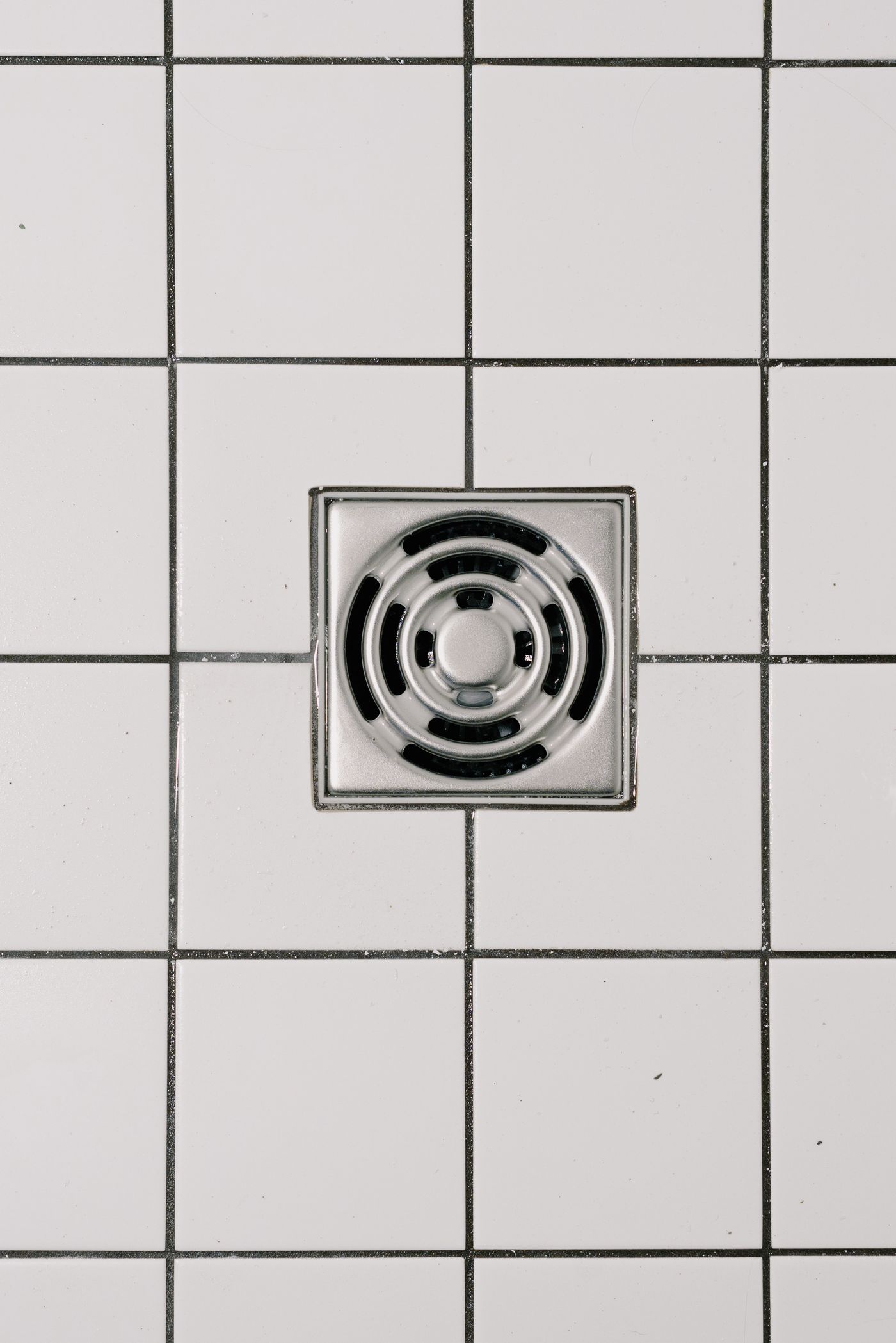A tiled bathroom floor drain, a common sewage backup point
